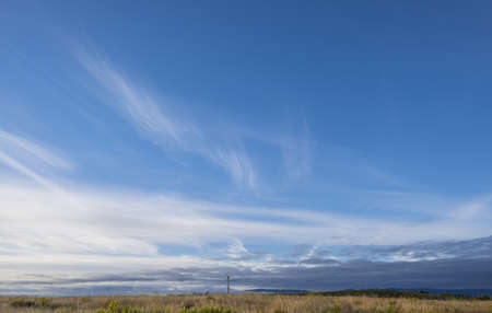 Detail of sky with thin and blurred clouds, summer day and heatの写真素材