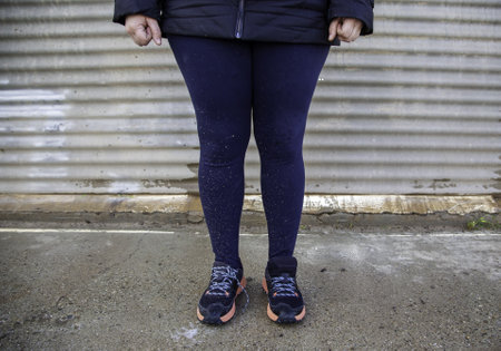 Detail of woman's legs splattered by mud and dirtの写真素材