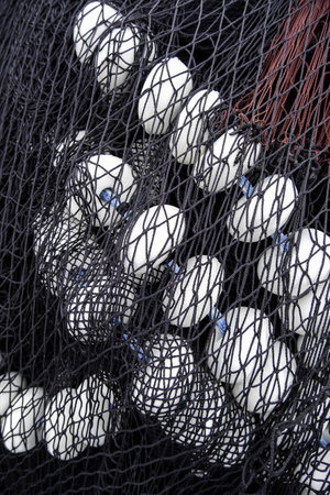 Detail of old deep sea fishing nets on a commercial dock