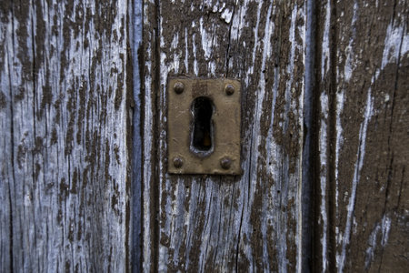 Detail of old and abandoned lock on a wooden door, ruinの写真素材