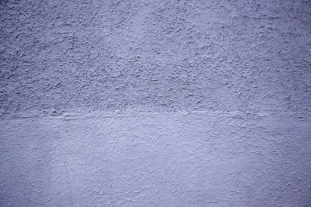Detail of rough cement wall painted blue, exterior decorationの写真素材