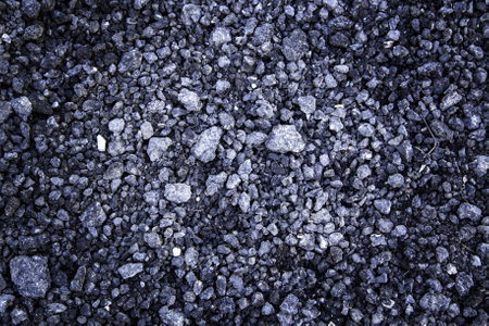 Detail of textured asphalt background, old and shabby roadの写真素材