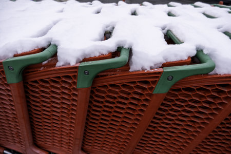 Detail of shopping carts in a supermarket on a winter and snowy day