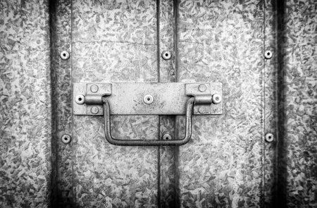 Detail of a metal handle to open and close a door on the streetの写真素材