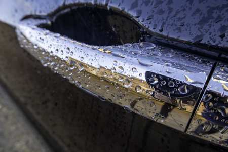 Detail of a modern electric car wet by the rain on a winter dayの写真素材