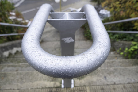 Detail of railing on a staircase, rainwater in winter