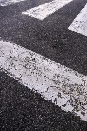Detail of zebra crossing for pedestrians on a road in the cityの写真素材