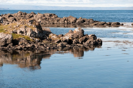 reflected in the sea cliffs of the peninsula in Iceland Vatnsnessの写真素材