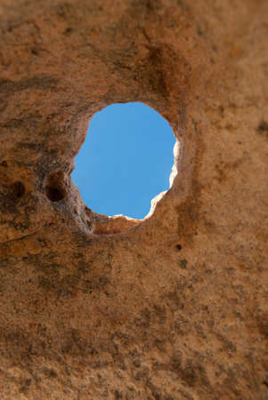 blue sky seen through a hole in the granite on the island of La Maddalena in Sardiniaの写真素材