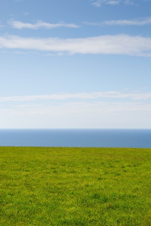 sea, grass and sky in Newquay in Cornwallの写真素材