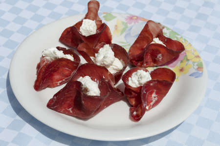 appetizer with slices of dried beef stuffed with cheeseの写真素材
