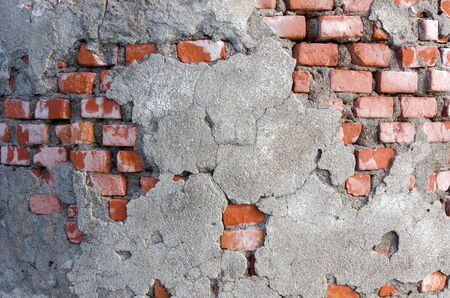 ruined wall with plaster and brickの写真素材