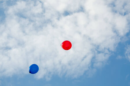 balloons flying in the cloudsの写真素材