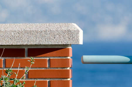 brick wall with railing on the seaの写真素材