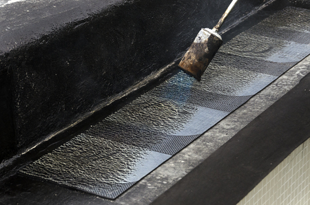 laying of waterproofing sheathing and insulation during the renovation of a roof in Italyの写真素材