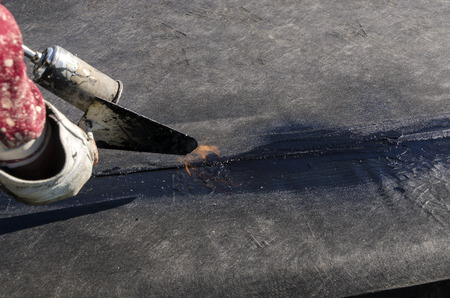 laying of waterproofing sheathing and insulation during the renovation of a roof in Italyの写真素材