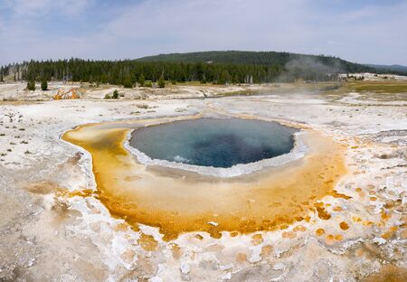 Geyser and hot spring in the old faithful basin in Yellowstone National Park in Wyomingの写真素材