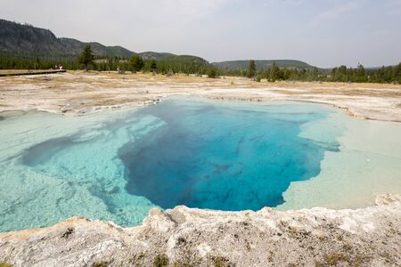 Geyser and hot spring in the old faithful basin in Yellowstone National Park in Wyomingの写真素材