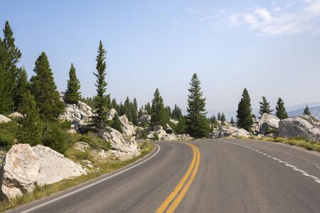 asphalt road in Yellowstone National Park in Wyomingの写真素材