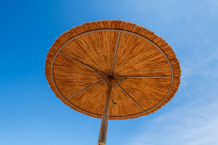 straw umbrellas on the beach at at Puta Zeza beach in Athens in Greeceの写真素材