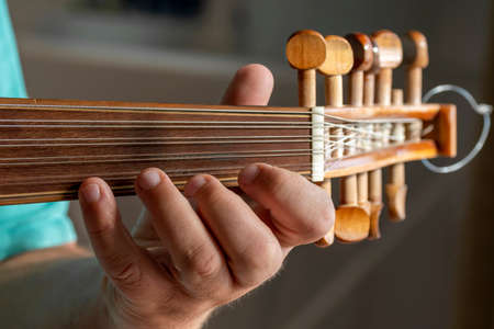 hands of a musician playing the lute in Greece