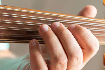 hands of a musician playing the lute in Greece