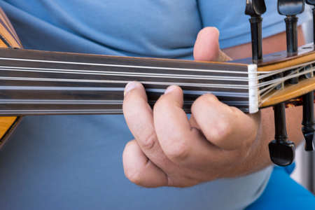 hands of a musician playing the lute in Greece