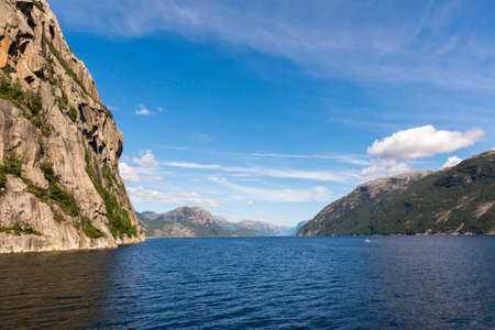 rock, islands, overhangs, cliffs and mountains overlooking the sea during a cruise on the Lysefjord fjord in Norwayの写真素材