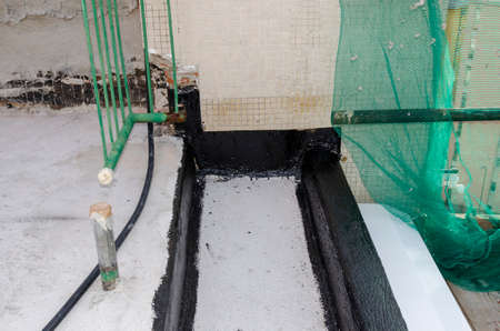 laying of waterproofing sheathing and insulation during the renovation of a roof in Italyの写真素材