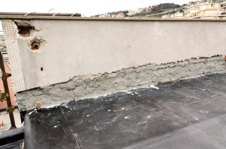 laying of waterproofing sheathing and insulation during the renovation of a roof in Italyの写真素材