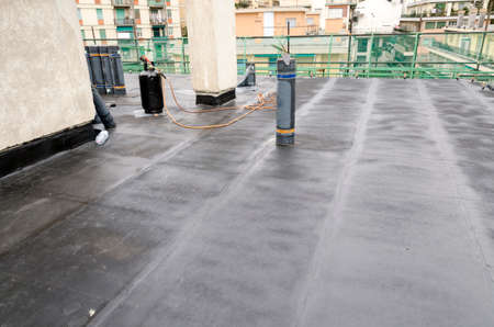 laying of waterproofing sheathing and insulation during the renovation of a roof in Italyの写真素材