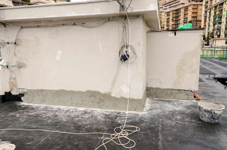 laying of waterproofing sheathing and insulation during the renovation of a roof in Italyの写真素材