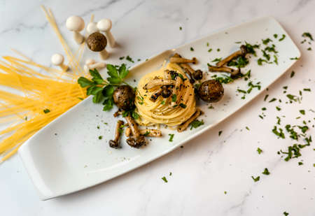 plate of gourmet italian pasta spaghetti with mushrooms and white backgroundの写真素材