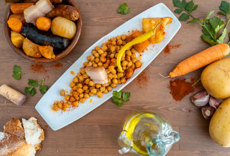 spanish traditional food cocido with chickpea and chorizo black pudding chickpeas bacon carrot potatoの写真素材