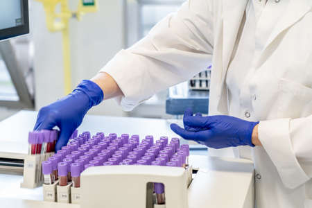 woman in laboratory doing tests for vaccine blood extraction and analytical