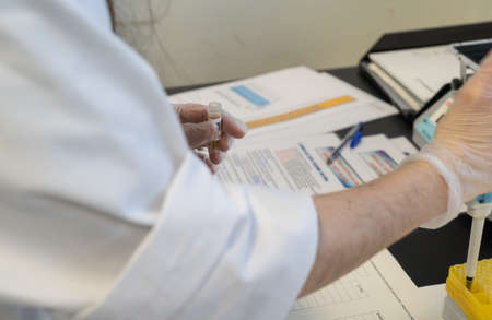 woman in laboratory doing tests for vaccine blood extraction and analyticalの写真素材