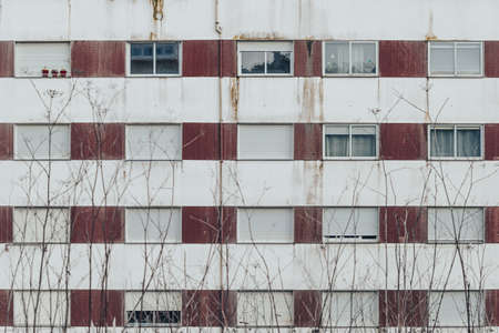 Front of an old building with open and closed shuttersの写真素材