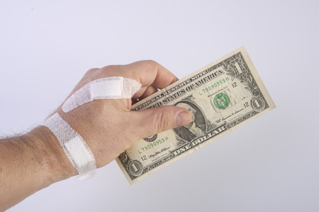 hand with certotti and banknote