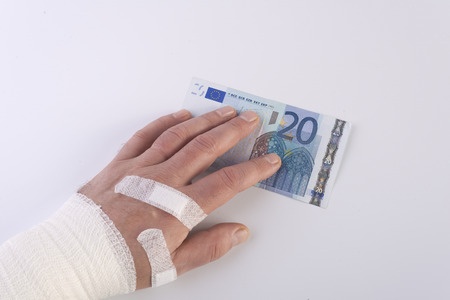 bandaged hand and patches and the  20 banknoteの写真素材