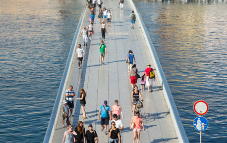 People strolling on a pedestrian bridge.のeditorial素材