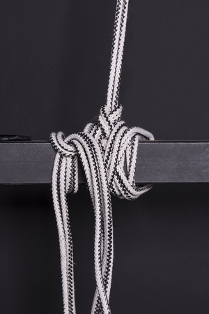 Knotted rope on a beamの写真素材