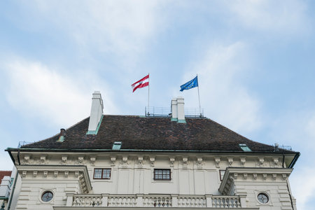 The European and Austrian flags on a roof in Viennaのeditorial素材