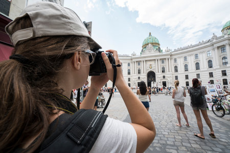 Tourist do a photo in the courtyard of the Hofburg castle in Viennaのeditorial素材