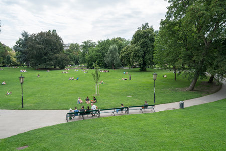 People rest on the grass of the Burggarten park in the center of Viennaのeditorial素材