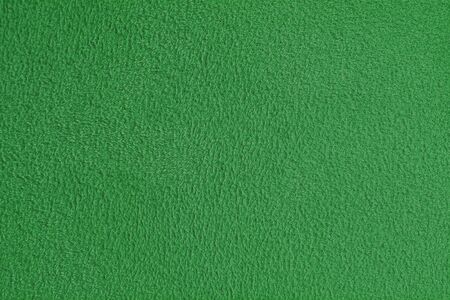 the texture of a green colored fabric as a backgroundの写真素材