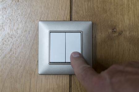 switch on a wood-covered wall