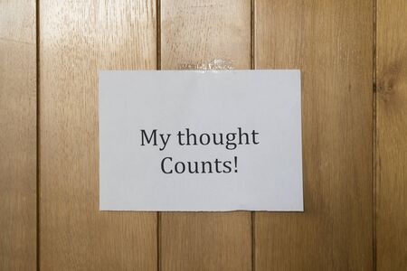 A sheet of paper written on the wooden wall