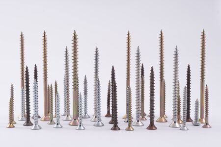 some screws of varying length arranged on a white plane like the skyline of a cityの写真素材