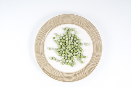 frozen peas on a plateの写真素材