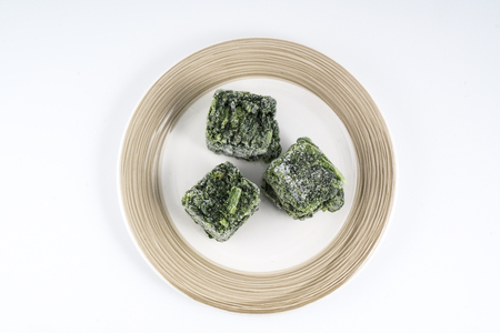 cubes of frozen spinach on a plateの写真素材